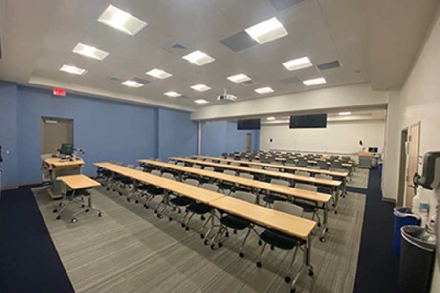 empty classroom with rows of tables and chairs