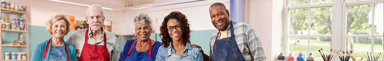 Adults enjoying a painting class together in a bright studio setting.